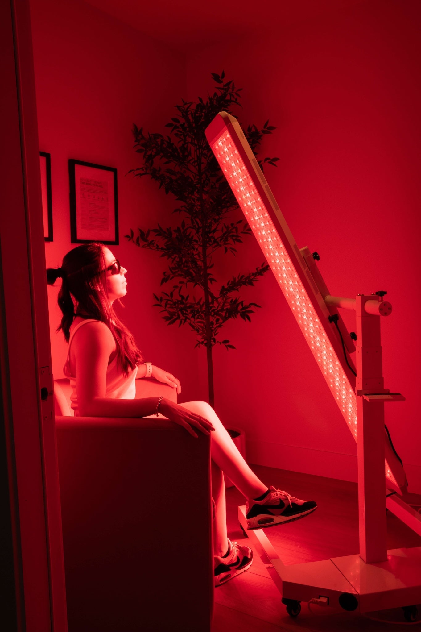 Renew Panorama full-body red light therapy panel on its rolling stand in use.